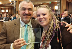 DanceSafe Executive Director, Missi Wooldridge, and founder Emanuel Sferios pose with the Dr. Andrew Weil Award for Achievement in the Field of Drug Education, awared by the Drug Policy Alliance