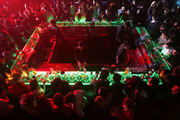 Guests hang out around the bar during a night out at the Baby Face night club in Shanghai